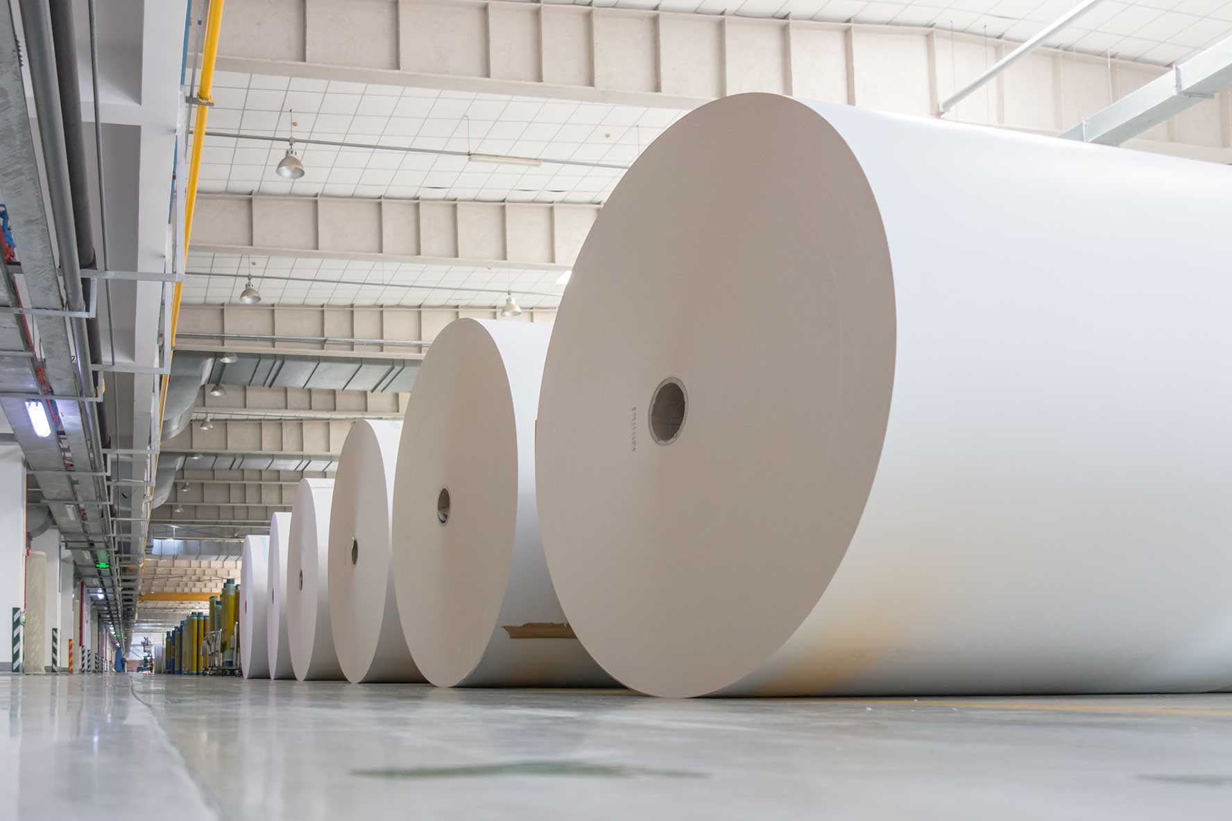 Huge industrial rolls placed in a warehouse