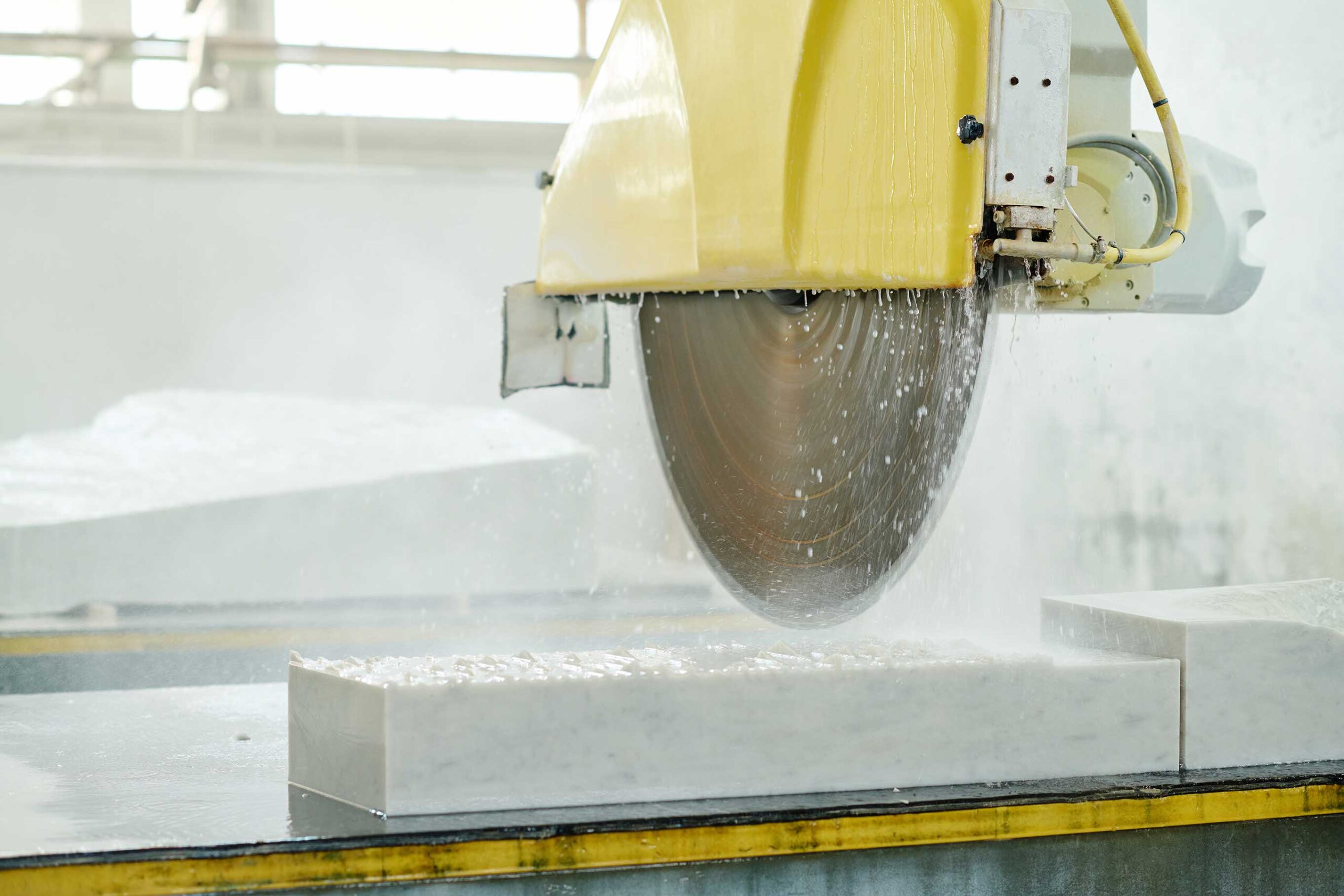 Close-up of work of lathe for cutting marble in factory of cutting stones